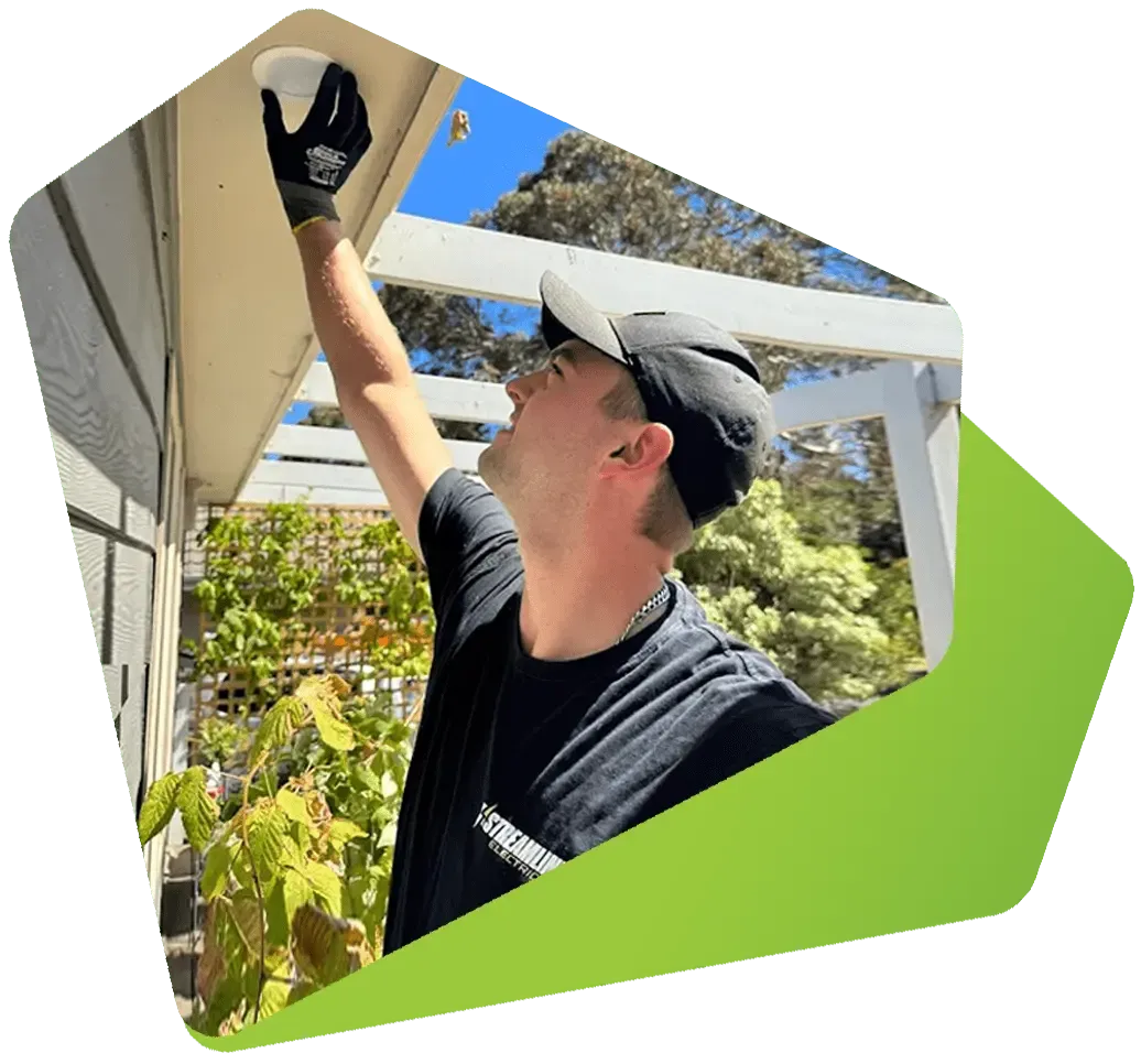 Streamline Electrical electrician installing a ceiling light on a pergola