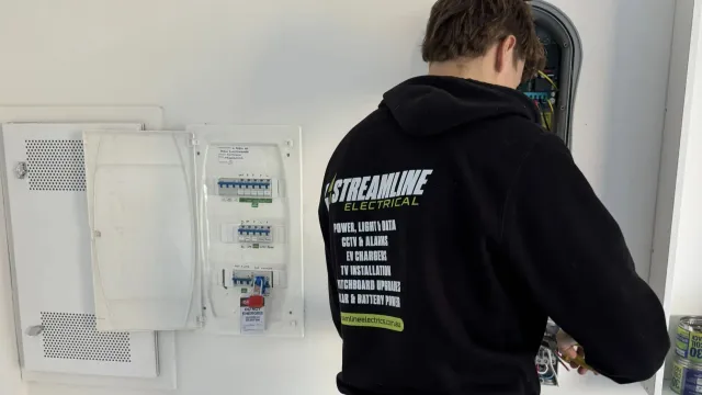 Streamline electrician working at a switchboard during a three phase upgrade in Carrum Downs