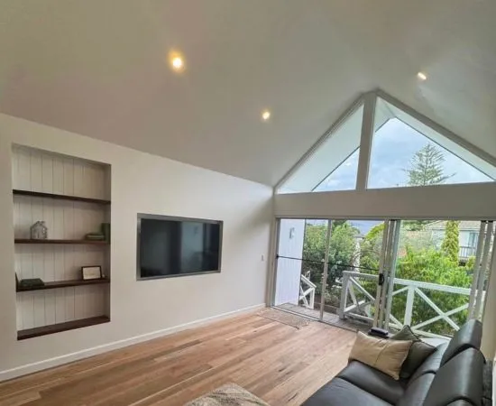 LED downlights installed across the raked ceiling of a living room with timber floors