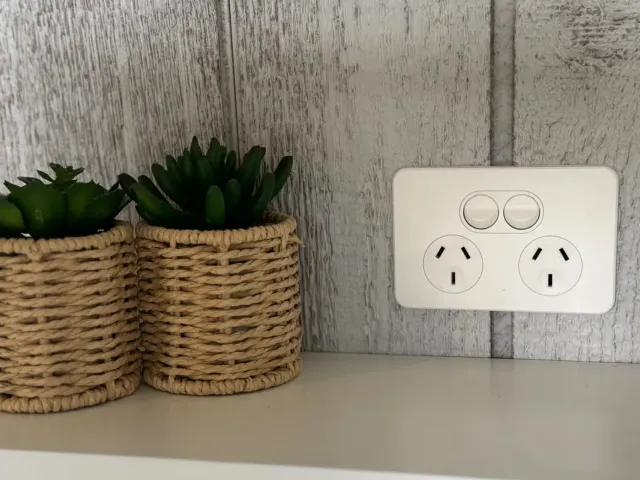 Electrician installing a power point in a home
