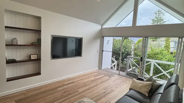 Raked-ceiling living room in Frankston South after a fan and lighting install